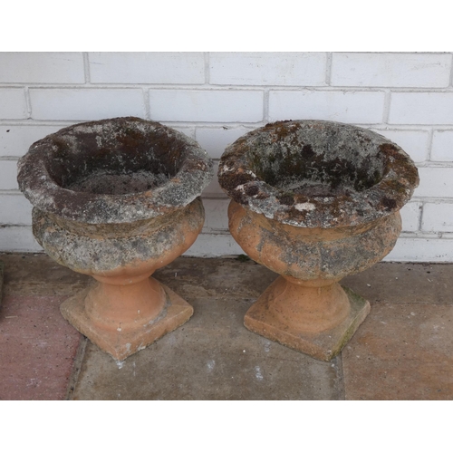 438 - A pair of terracotta coloured concrete garden urns, approx 15