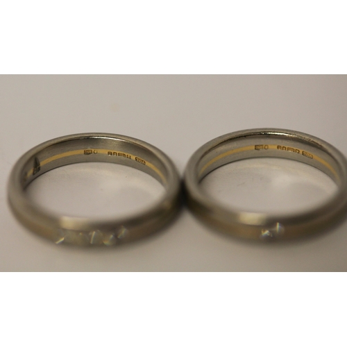 506 - A pair of 18ct yellow gold and platinum wedding bands, each set with brilliant cut diamonds. Full ha... 