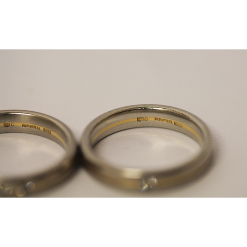 506 - A pair of 18ct yellow gold and platinum wedding bands, each set with brilliant cut diamonds. Full ha... 