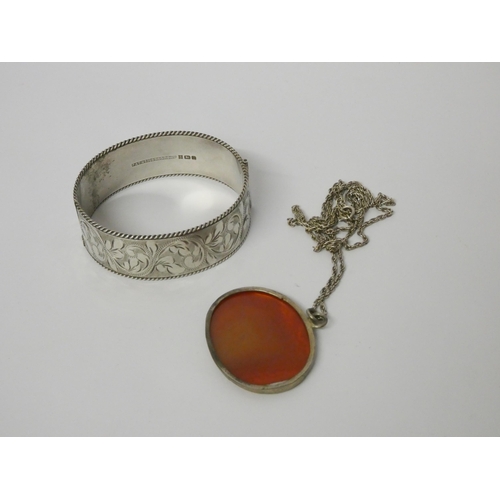 513 - A silver hinged bangle and an Arabic pendant on German 835 silver chain