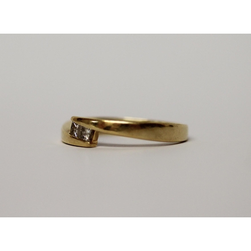 521 - 18ct yellow gold band set with two princess cut diamonds in an offset design, marked 18ct & makers m... 