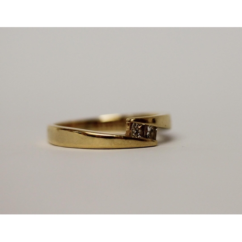 521 - 18ct yellow gold band set with two princess cut diamonds in an offset design, marked 18ct & makers m... 