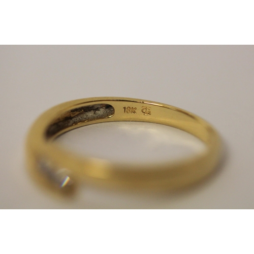 521 - 18ct yellow gold band set with two princess cut diamonds in an offset design, marked 18ct & makers m... 