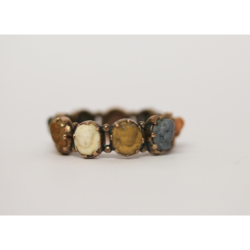 522 - 19th century lava cameo ring, set with nine oval carved lava cameos in yellow metal claw settings. S... 