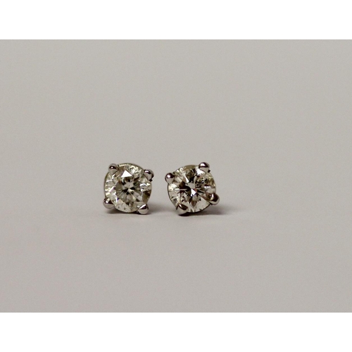 540 - A pair of diamond ear studs, the brilliant cut diamonds on hallmarked 18ct white gold posts.