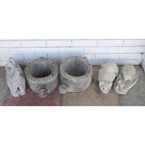 464 - A pair of reconstituted stone watering can shaped garden planters, a cat stone ornament, hedgehog an... 