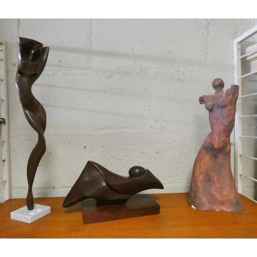 253 - Two contemporary teak abstract sculptures and a terracotta sculpture of a nude, tallest piece measur... 