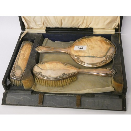 644 - A three piece silver backed dressing table set in fitted case, engraved with initial A