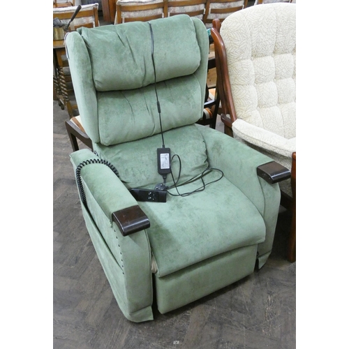 51 - Electric rise and recline easy chair in green covering