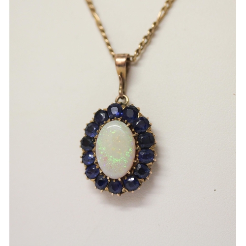 589 - A large oval sapphire and opal cluster pendant on 9ct gold chain. Pendant 33mm long including droppe... 