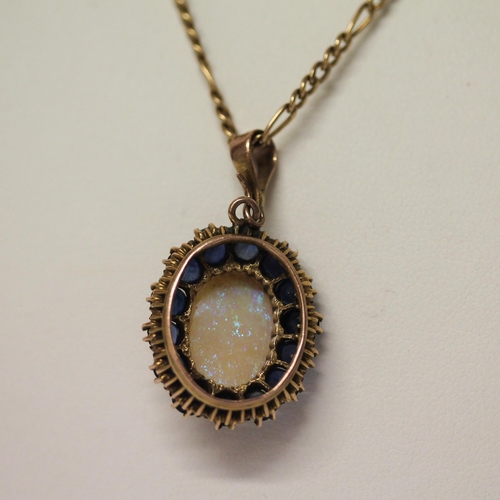 589 - A large oval sapphire and opal cluster pendant on 9ct gold chain. Pendant 33mm long including droppe... 