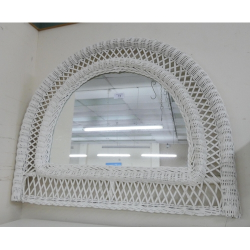 11 - A semi-circular white cane framed wall mirror, 2'6 wide