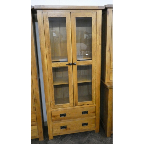 2 - A top quality light oak glazed two door bookcase with two drawers under, 2'9 wide