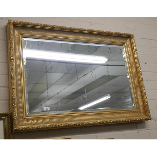 23 - A large bevelled wall mirror in decorative gilt frame, approximately 27