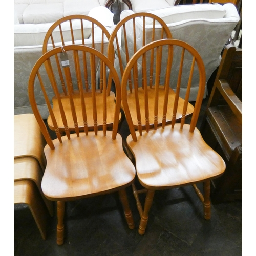 46 - A set of four spindle back Windsor dining chairs with panel seats