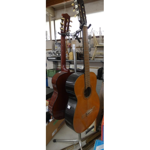 346 - A double guitar stand with a Kivara Classical Guitar, a Hohner guitar and two music stands