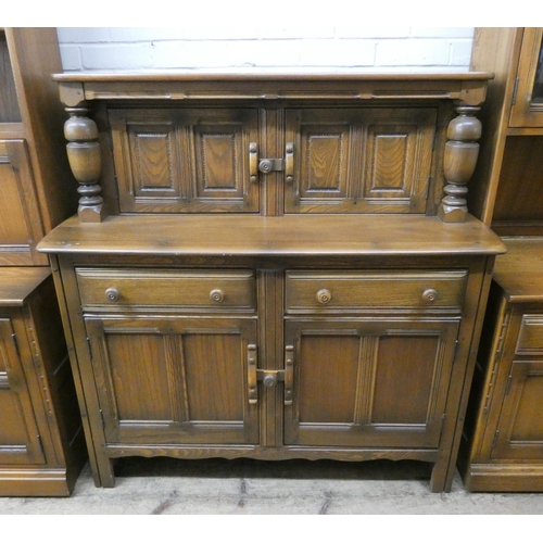 19 - An Ercol Golden Dawn court cupboard with cabinet back, drawers and cupboards under, 4' wide