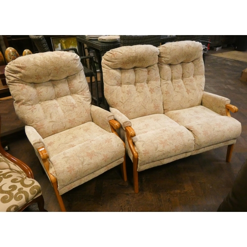 113 - A small wood framed two seater settee in cream and floral fabric and a matching high seat fireside c... 