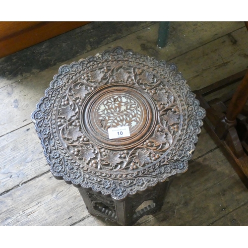 10 - A small carved wood Moorish coffee table with inlaid top