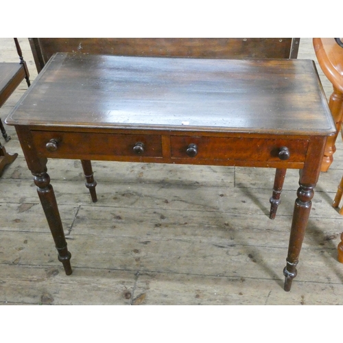 54 - A Victorian mahogany writing or side table fitted with two drawers on turned legs, 3' wide