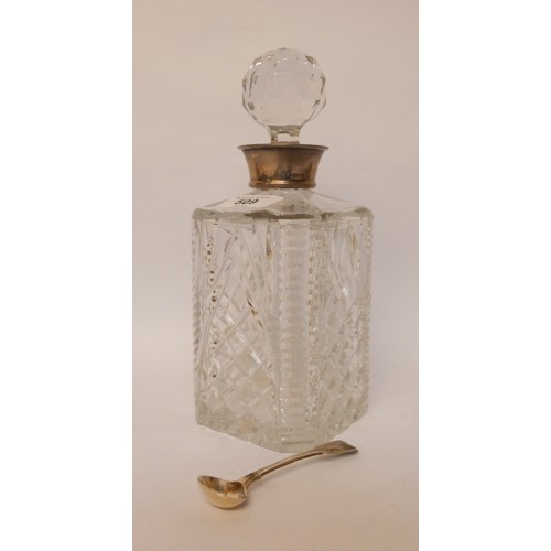 509 - A cut glass decanter with hallmarked silver rim together with a hallmark silver salt spoon