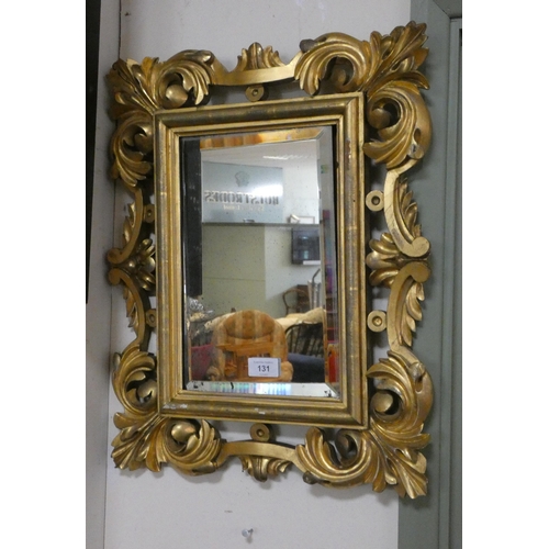 131 - A small Georgian style bevelled wall mirror in carved wood gilt frame