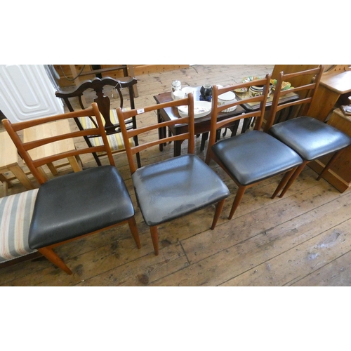 66 - A set of four mid-century teak ladder back chairs with black vinyl seats