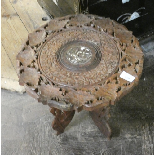 134 - A small circular carved wood Moorish style coffee table