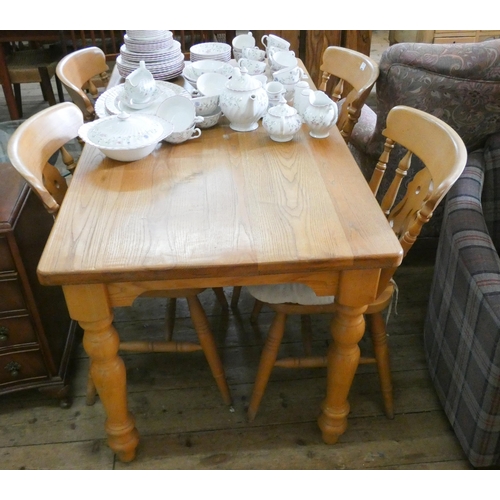 73 - A pine farmhouse style dining table and a set of four Windsor style chairs to match with seat pads