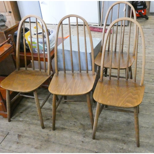 76 - A set of four spindle back Windsor style dining chairs with panel seats