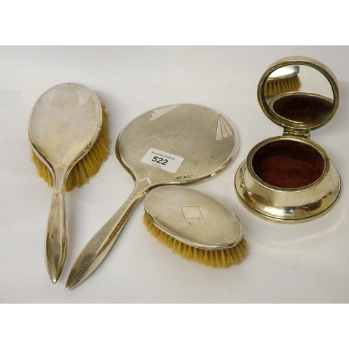 522 - A three piece silver backed dressing table set and a circular trinket box with hinged lid.