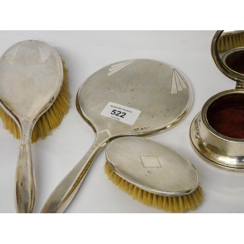 522 - A three piece silver backed dressing table set and a circular trinket box with hinged lid.