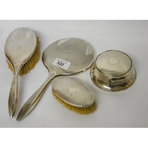 522 - A three piece silver backed dressing table set and a circular trinket box with hinged lid.