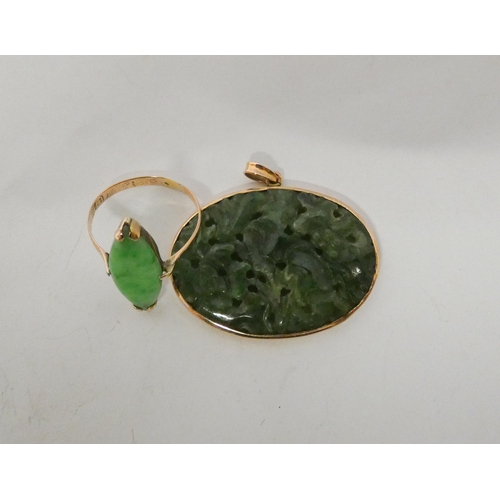 622 - An oval pierced jade pendant in gold frame and a marquis shaped ring with Chinese character hallmark... 