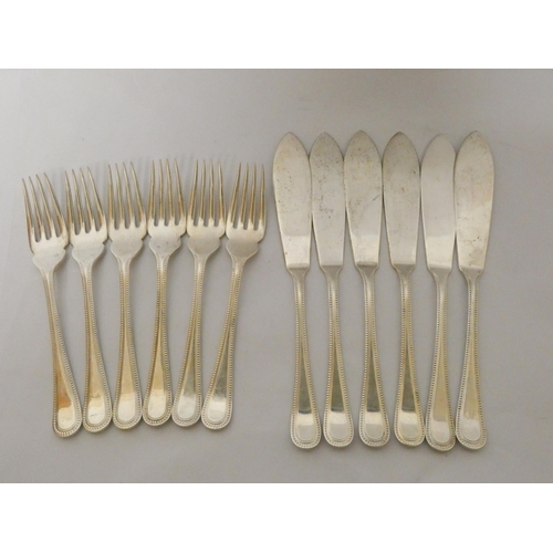 530 - A set of six hallmarked silver fish knives and matching forks with beaded edge, 22.7 troy ozs