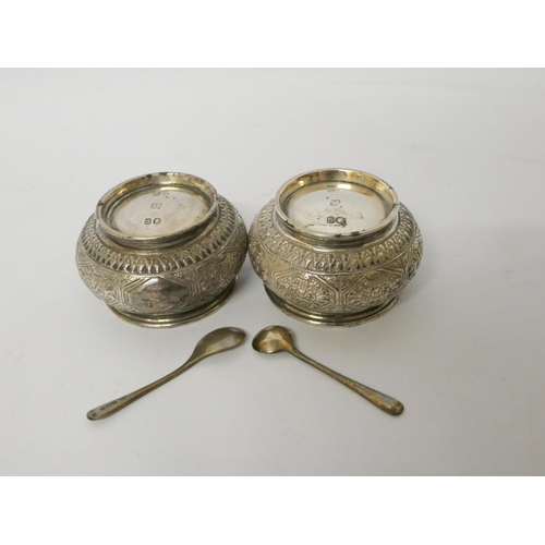 531 - A pair of Victorian circular silver salt cellars, hallmarked London 1873, all over engraved decorati... 