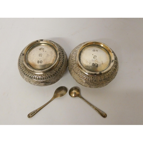 531 - A pair of Victorian circular silver salt cellars, hallmarked London 1873, all over engraved decorati... 