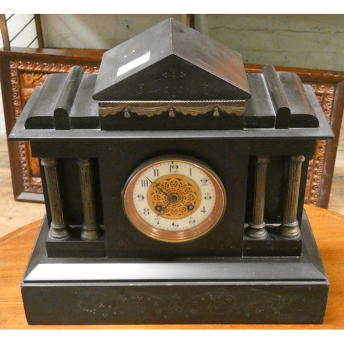 153 - A Victorian striking mantle clock in black marble case with Corinthian columns