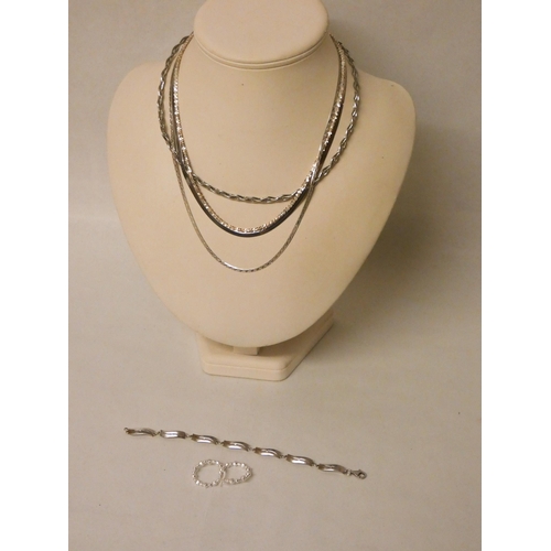 608 - A Hot Diamonds silver bracelet, pair of silver hoop earrings and four silver necklaces and chains.