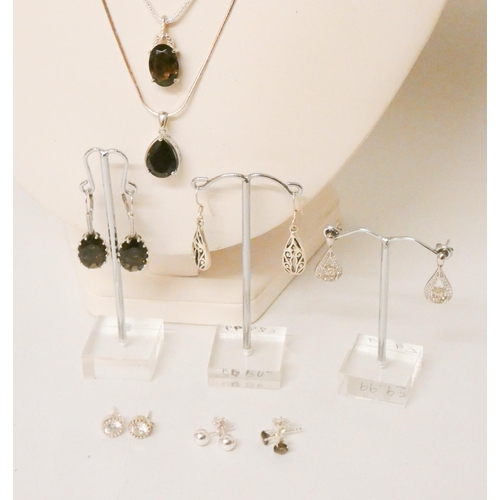 609 - Six pairs of silver earrings and two pendants on silver chains, set with smoky quartz.