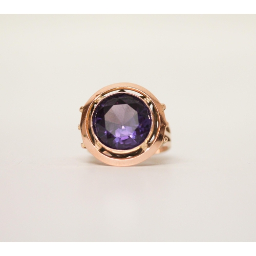 623 - A single stone ring, the circular colour change spinel within collet setting on a rose gold band, in... 