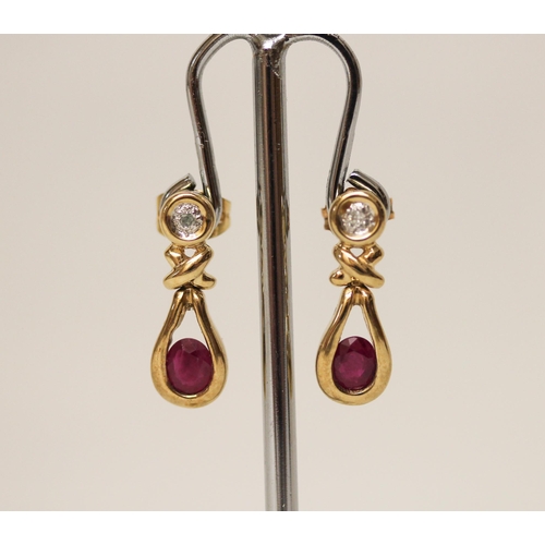 593 - A pair of modern 9ct yellow gold, ruby and diamond drop earrings. Hallmarked on posts. Gross weight ... 