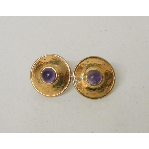 613 - A pair of amethyst and gold circular shield shaped pierced earrings, hallmarked 9ct gold. Gross weig... 