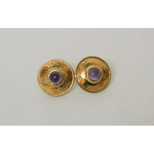 613 - A pair of amethyst and gold circular shield shaped pierced earrings, hallmarked 9ct gold. Gross weig... 