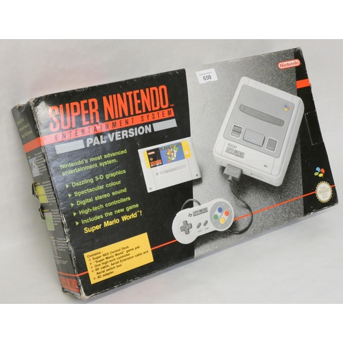 650 - A boxed Super Nintendo Entertainment System with Super Mario World game