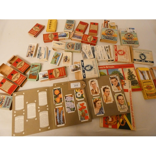 311 - A shoe box full of cigarette cards in sets and part sets, titles to include speed, railway equipment... 