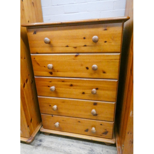 20 - A pair of modern varnished pine five drawer bedroom chests