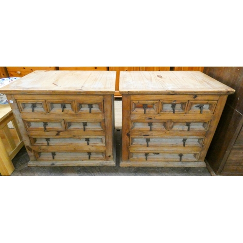 23 - A pair of Mexican pine bedside chests, fitted in an arrangement of long and short drawers