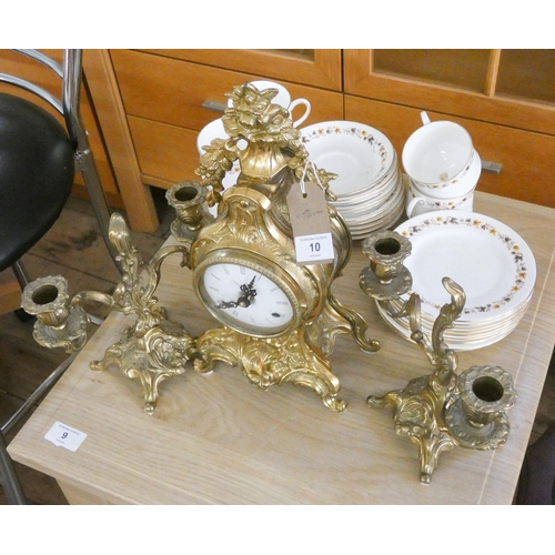 10 - A modern brass three piece clock garniture and a part Royal Kent china tea set