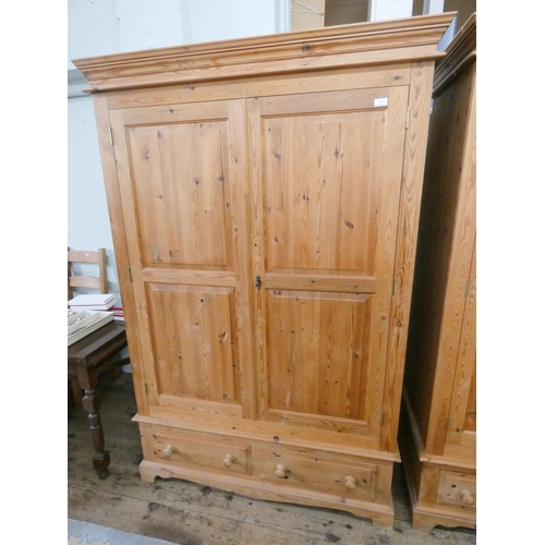 108 - A Victorian style pine two door wardrobe with two drawers under, 4' wide